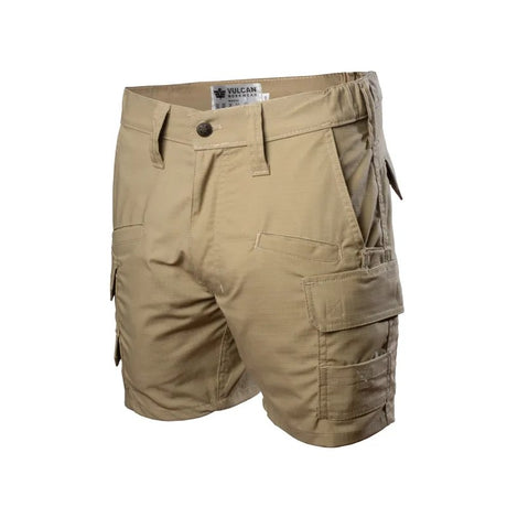 A pair of tan cargo shorts with multiple utility pockets and belt loops, shown against a plain white background. The brand label 'VULCAN WORKWEAR' is visible inside the waistband.